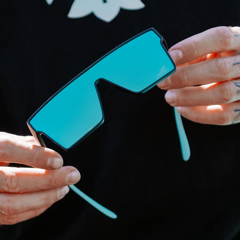 A person smiling comfortably while wearing well-fitting sunglasses