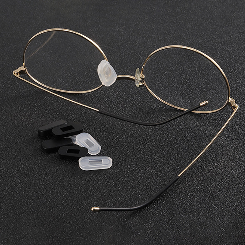 A diagram of sunglasses with labels pointing to the frame, lens, hinge, temple, and nose pads.