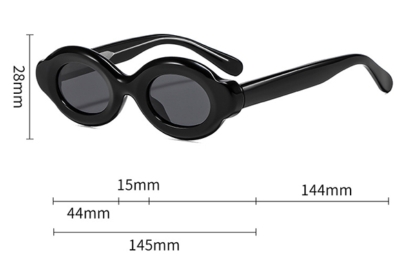 A person using a ruler to measure a pair of sunglasses at home