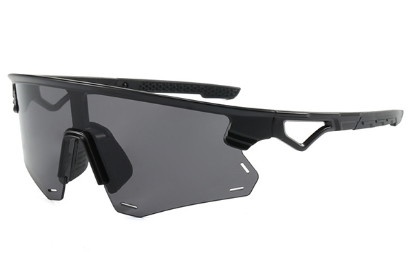 A cyclist wearing yellow-lensed cycling glasses on an overcast day