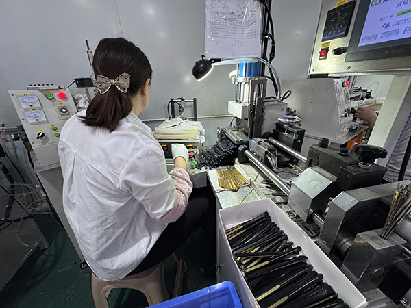 A factory audit checklist being reviewed against a backdrop of manufacturing equipment.