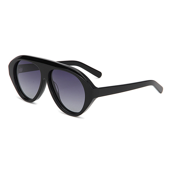A woman wearing big-frame retro pilot acetate sunglasses outdoors
